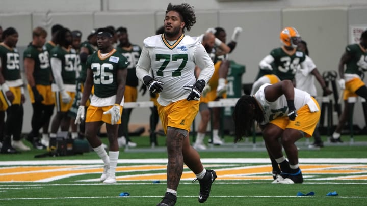 Green Bay Packers offensive tackle Jordan Morgan (77) gets warmed up during minicamp. 