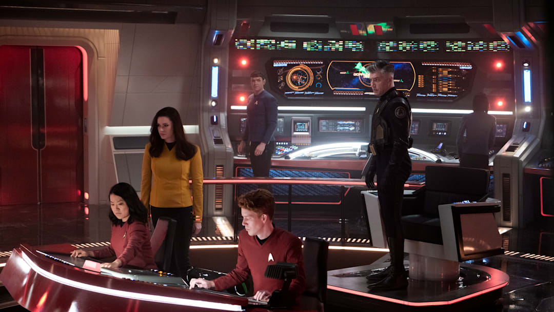 L-R Rong Fu as Mitchell, Rebecca Romijn as Una, Ethan Peck as Spock and Anson Mount as Capt. Pike in Star Trek: Strange New Worlds streaming on Paramount+, 2023. Photo Credit: Michael Gibson/Paramount+
