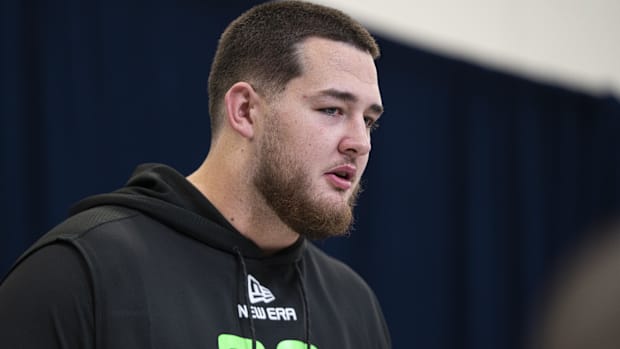 Offensive lineman Wyatt Milum (black sweatshirt) answers questions from the national media.
