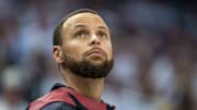 Golden State Warriors guard Stephen Curry looks on from the bench against the Minnesota Timberwolves.