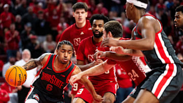Feb 9, 2025; Lincoln, Nebraska, USA; Ohio State Buckeyes guard Ques Glover (6) drives against Nebraska Cornhuskers guard Brice Williams (3) and guard Rollie Worster (24) during the second half at Pinnacle Bank Arena. Mandatory Credit: Dylan Widger-Imagn Images