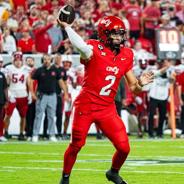 Aug 28, 2025; Kansas City, Missouri, USA; Cincinnati Bearcats quarterback Brendan Sorsby (2) passes against Nebraska Cornhuskers defensive lineman Keona Davis (97) during the second quarter at GEHA Field at Arrowhead Stadium. Mandatory Credit: Dylan Widger-Imagn Images