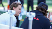 Injured Cincinnati Bengals quarterback Joe Burrow (9) talks on the bench with injured defensive end Trey Hendrickson (91) in the second quarter of the NFL Week 12 game between the Cincinnati Bengals and the New England Patriots at Paycor Stadium in downtown Cincinnati on Sunday, Nov. 23, 2025.