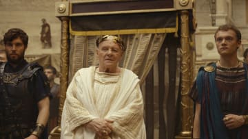 THOSE ABOUT TO DIE -- Episode 101 --Pictured: (l-r) Tom Hughes as Titus, Anthony Hopkins as Emperor Vespasian, Jojo Macari as Domitian (Photo by: PEACOCK)