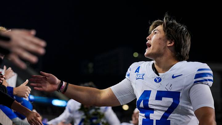 Nov 22, 2025; Cincinnati, Ohio, USA; BYU Cougars quarterback Bear Bachmeier celebrates with fans after defeating the Cincinnati Bearcats at Nippert Stadium. Mandatory Credit: Aaron Doster-Imagn Images