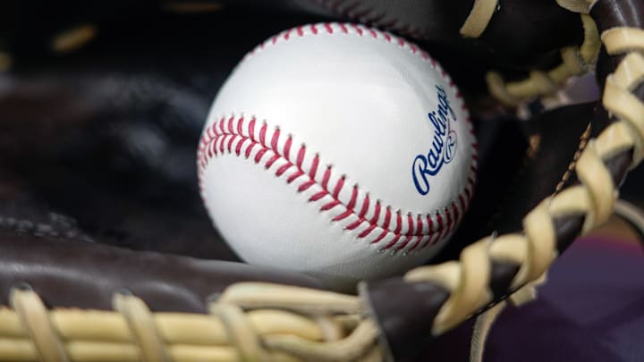 Apr 18, 2025; Milwaukee, Wisconsin, USA;  General view of a baseball in a glove during batting practice prior to the game between the Athletics and Milwaukee Brewers at American Family Field. Mandatory Credit: Jeff Hanisch-Imagn Images