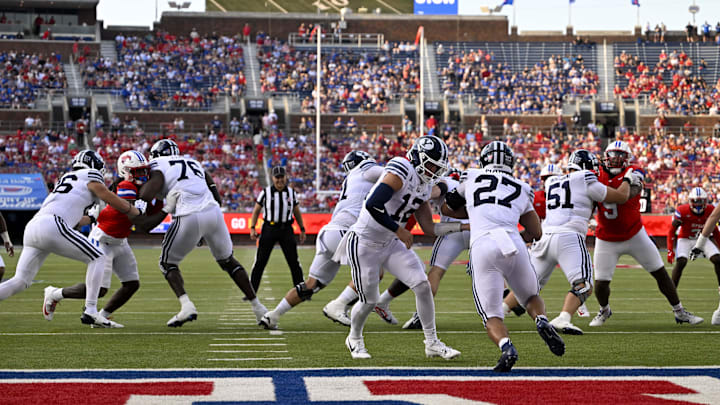 Sep 6, 2024; Dallas, Texas, USA; Brigham Young Cougars quarterback Jake Retzlaff (12) and running back LJ Martin (27) in action during the game between the Southern Methodist Mustangs and the Brigham Young Cougars at Gerald J. Ford Stadium.