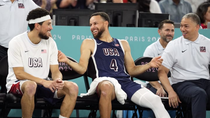 Aug 6, 2024; Paris, France; United States guard Devin Booker (15) and shooting guard Stephen Curry (4) and assistant coach Tyronn Lue look on in the second half against Brazil in a men’s basketball quarterfinal game during the Paris 2024 Olympic Summer Games at Accor Arena. Mandatory Credit: Kyle Terada-USA TODAY Sports