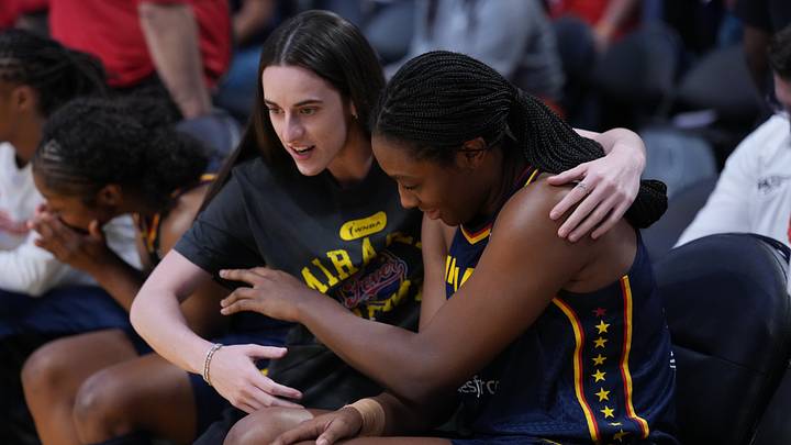 Aug 5, 2025; Los Angeles, California, USA; Indiana Fever guard Caitlin Clark (22) puts her arm around forward Aliyah Boston (7) in the first half against the LA Sparks at Crypto.com Arena. Mandatory Credit: Kirby Lee-Imagn Images