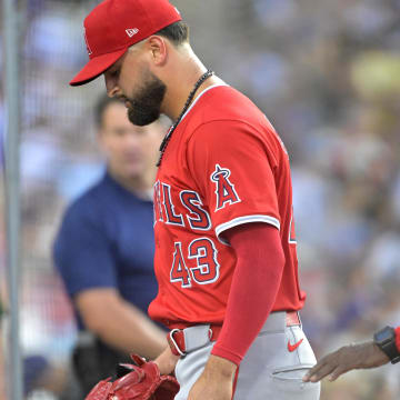 Jun 21, 2024; Los Angeles, California, USA;  Los Angeles Angels starting pitcher Patrick Sandoval (43) is followed by manager Ron Washington (37) as he leaves the game after an injury during the third inning against the Los Angeles Dodgers at Dodger Stadium. Mandatory Credit: Jayne Kamin-Oncea-USA TODAY Sports
