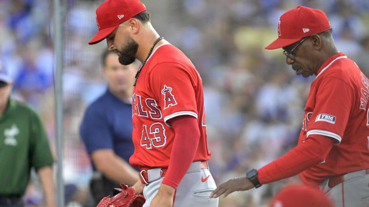 Jun 21, 2024; Los Angeles, California, USA;  Los Angeles Angels starting pitcher Patrick Sandoval (43) is followed by manager Ron Washington (37) as he leaves the game after an injury during the third inning against the Los Angeles Dodgers at Dodger Stadium. Mandatory Credit: Jayne Kamin-Oncea-USA TODAY Sports