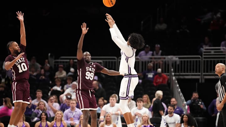 Nov 20, 2025; Kansas City, Missouri, USA; Kansas State Wildcats guard Abdi Bashir Jr. (1) shoots a three point basket as Mississippi State Bulldogs guard Jayden Epps (10) defends during the second half of the game at T-Mobile Center. Mandatory Credit: Denny Medley-Imagn Images