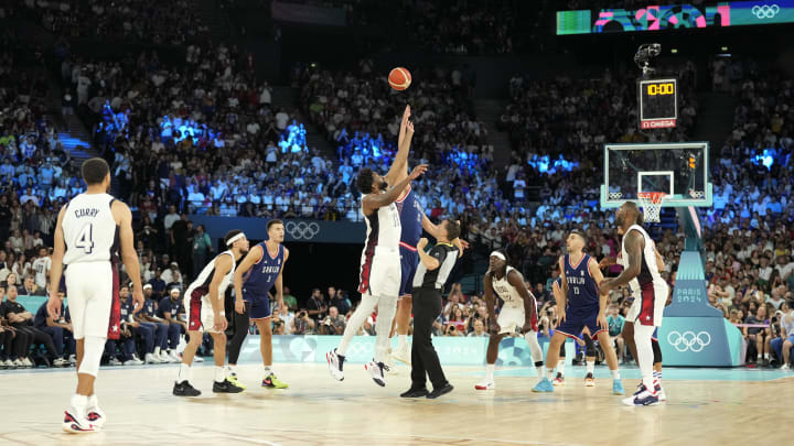 Aug 8, 2024; Paris, France; United States centre Joel Embiid (11) and Serbia power forward Nikola Jokic (15) take the opening tip-off in a men's basketball semifinal game during the Paris 2024 Olympic Summer Games at Accor Arena. Mandatory Credit: Kyle Terada-USA TODAY Sports