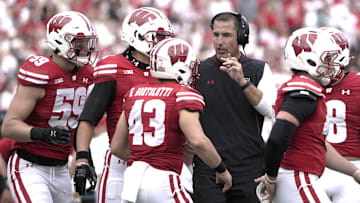 Sep 20, 2025; Madison, Wisconsin, USA; Wisconsin Badgers head coach Luke Fickell talks to his players during the second quarter of their game against the Maryland Terrapins at Camp Randall Stadium. Mandatory Credit: Mark Hoffman/USA Today Network via Imagn Images