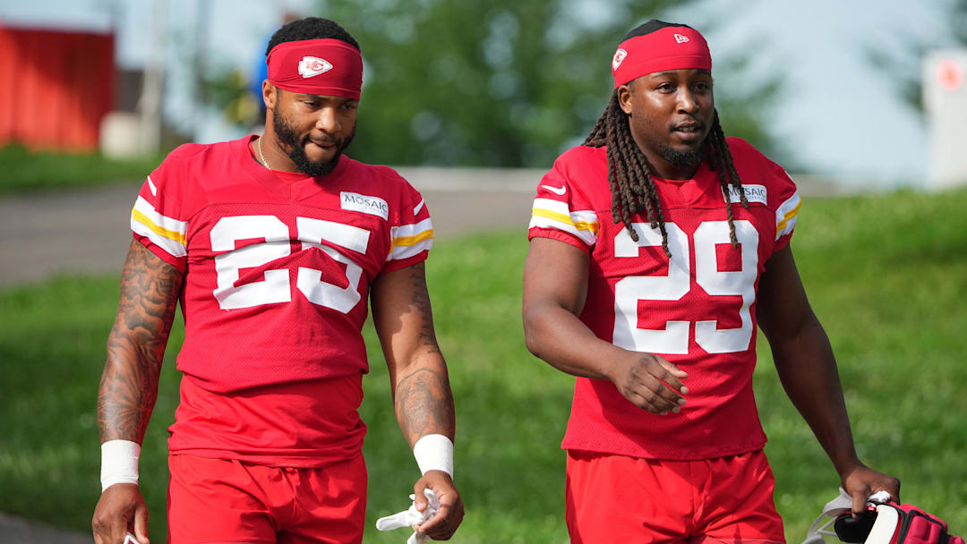 Jul 22, 2025; St. Joseph, MO, USA; Kansas City Chiefs running backs Elijah Mitchell (25) and Kareem Hunt (29) walk down the hill to the fields prior to training camp at Missouri Western State University. Mandatory Credit: Denny Medley-Imagn Images