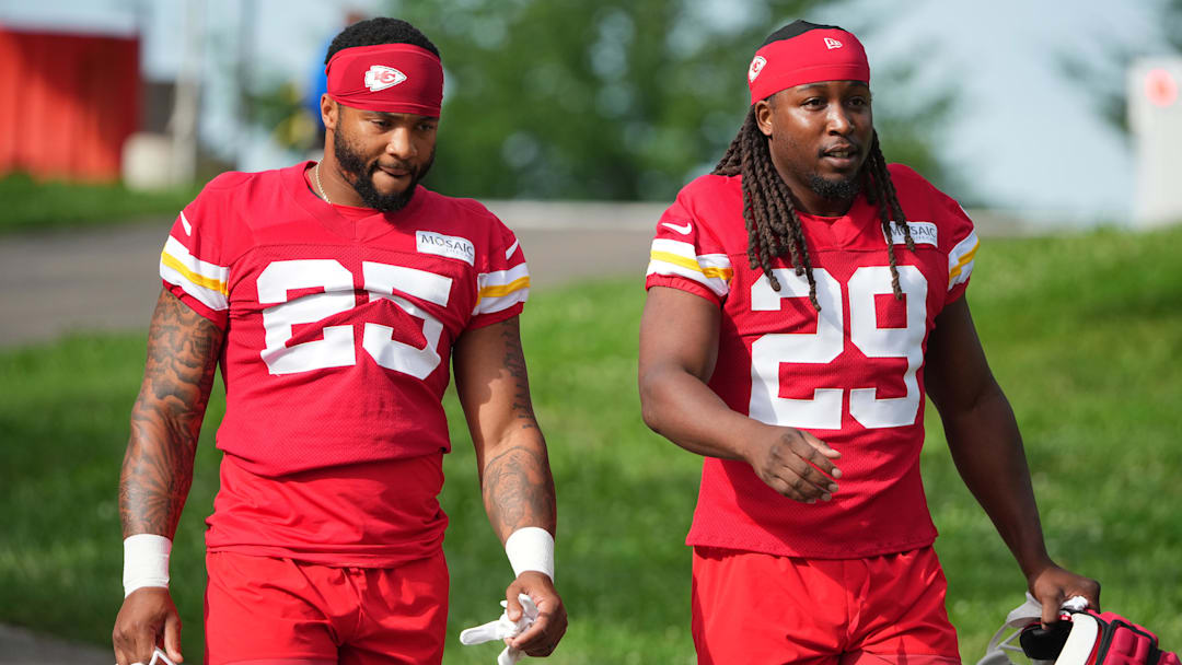 Jul 22, 2025; St. Joseph, MO, USA; Kansas City Chiefs running backs Elijah Mitchell (25) and Kareem Hunt (29) walk down the hill to the fields prior to training camp at Missouri Western State University. Mandatory Credit: Denny Medley-Imagn Images