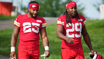 Jul 22, 2025; St. Joseph, MO, USA; Kansas City Chiefs running backs Elijah Mitchell (25) and Kareem Hunt (29) walk down the hill to the fields prior to training camp at Missouri Western State University. Mandatory Credit: Denny Medley-Imagn Images