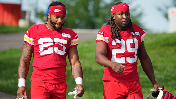 Jul 22, 2025; St. Joseph, MO, USA; Kansas City Chiefs running backs Elijah Mitchell (25) and Kareem Hunt (29) walk down the hill to the fields prior to training camp at Missouri Western State University. Mandatory Credit: Denny Medley-Imagn Images