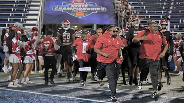 The Raines football enters the field to begin the Class 3A state championship against Miami Northwestern on Dec. 14, 2024.