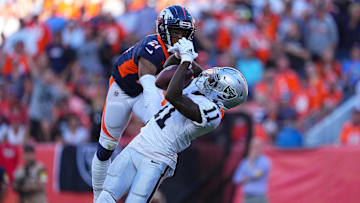 Las Vegas Raiders wide receiver Henry Ruggs III pulls in a reception past Denver Broncos cornerback Ronald Darby