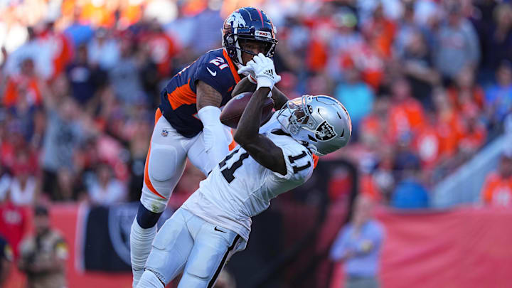 Las Vegas Raiders wide receiver Henry Ruggs III pulls in a reception past Denver Broncos cornerback Ronald Darby
