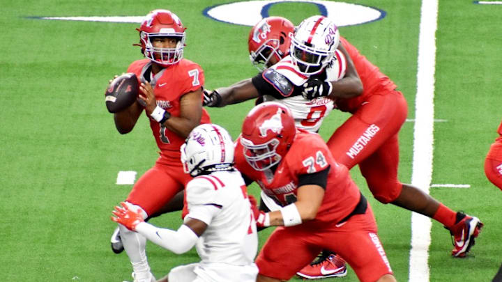 Galena Park North Shore quarterback Kaleb Maryland drops back in the pocket with pressure from Duncanville defenders in the Class 6A Division 1 championship game held Saturday, Dec. 20 in Arlington.