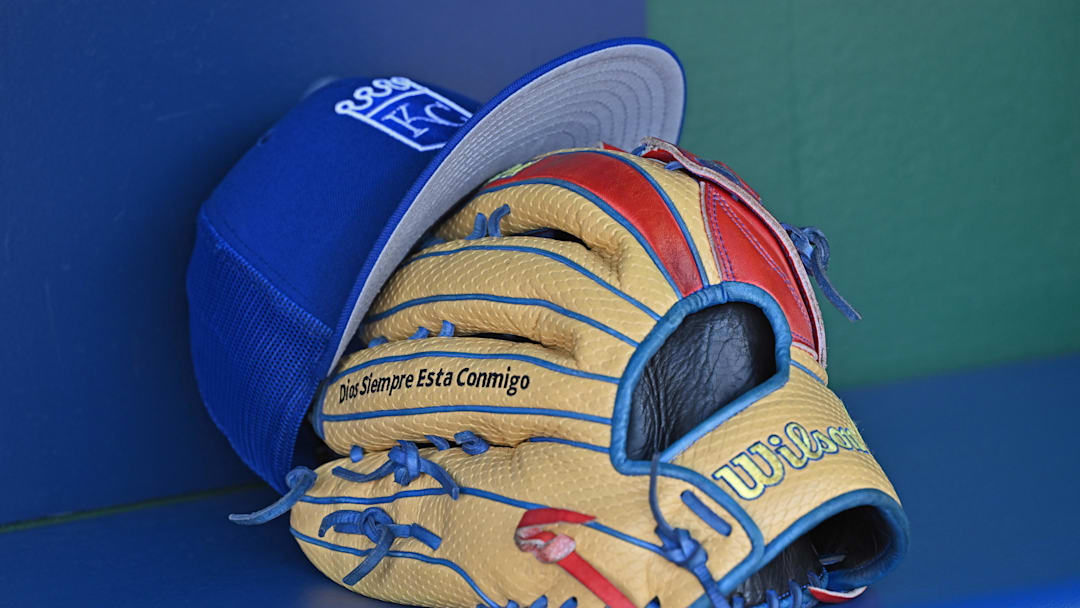 Aug 12, 2023; Kansas City, Missouri, USA;  Detailed view of a Kansas City Royals hat and glove before a game  against the St. Louis Cardinals at Kauffman Stadium. Mandatory Credit: Peter Aiken-Imagn Images