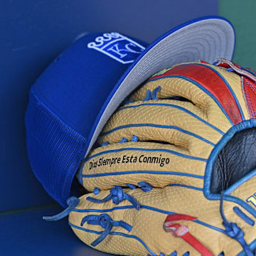 Aug 12, 2023; Kansas City, Missouri, USA;  Detailed view of a Kansas City Royals hat and glove before a game  against the St. Louis Cardinals at Kauffman Stadium. Mandatory Credit: Peter Aiken-Imagn Images
