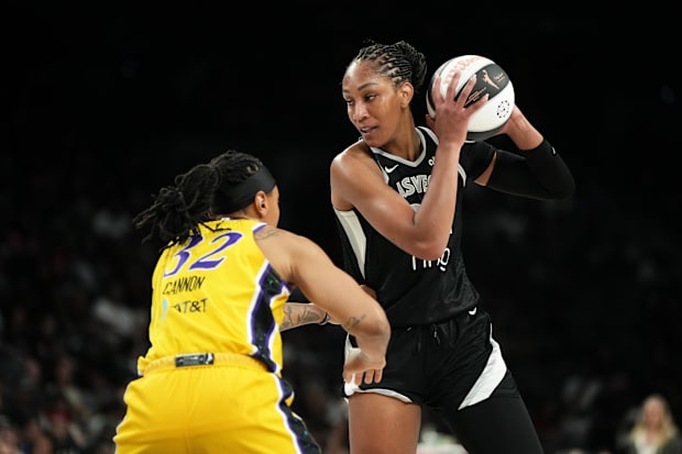Aces center A'ja Wilson (22) controls the ball against Los Angeles Sparks forward Emma Cannon