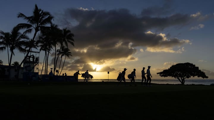 Ben Kohles, Alexander Bjork, and Aguri Iwasaki walk on the 17th hole during the continuation of the first round of the Sony Open in Hawaii golf tournament at Waialae Country Club on Jan. 12, 2024. 