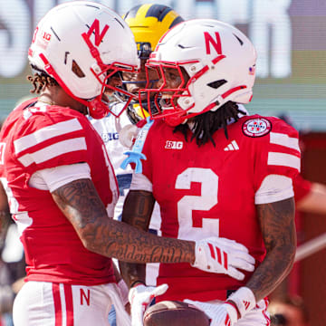 Jacory Barney Jr. and Nyziah Hunter celebrate after the hail-mary touchdown grab to end the first half. 