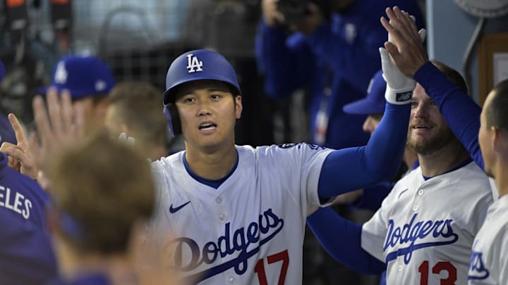 Los Angeles Dodgers designated hitter Shohei Ohtani celebrates in the dugout after hitting a solo home run against the Colorado Rockies.