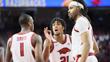 Mar 8, 2025; Fayetteville, Arkansas, USA; Arkansas Razorbacks guard D.J. Wagner (21) talks to guard Johnell Davis (1) and forward Jonas Aidoo (9) during the first half against the Mississippi State Bulldogs at Bud Walton Arena. Mandatory Credit: Nelson Chenault-Imagn Images