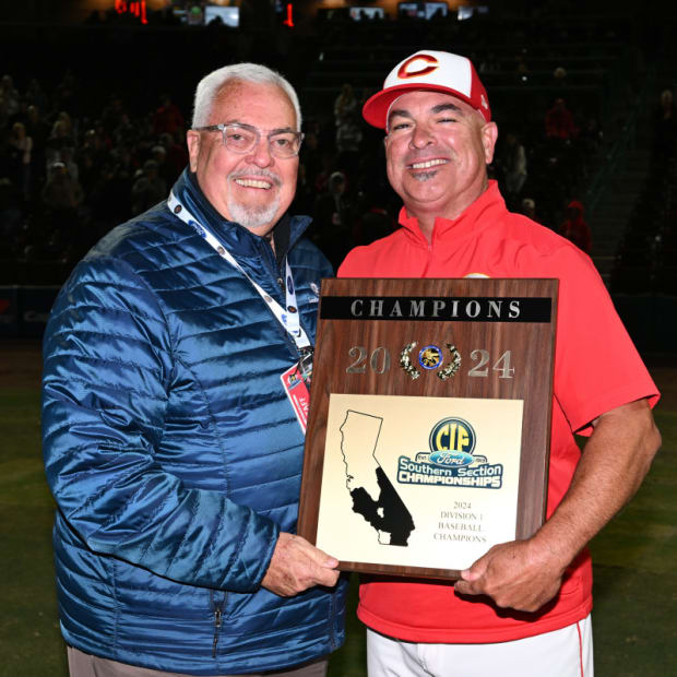 Corona High baseball coach Andy Wise (right) awarded with the CIF Southern Section Division 1 plaque at Diamond Stadium in La