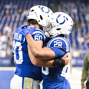 Oct 26, 2025; Indianapolis, Indiana, USA; Indianapolis Colts running back Jonathan Taylor (28) and Indianapolis Colts center Tanor Bortolini (60) warm up before the game against the Tennessee Titans at Lucas Oil Stadium. Mandatory Credit: Robert Goddin-Imagn Images