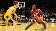 Feb 8, 2025; Iowa City, Iowa, USA; Wisconsin Badgers guard John Blackwell (25) looks to shoot against Iowa Hawkeyes forward Payton Sandfort (20) during the first half at Carver-Hawkeye Arena. Mandatory Credit: Dylan Widger-Imagn Images