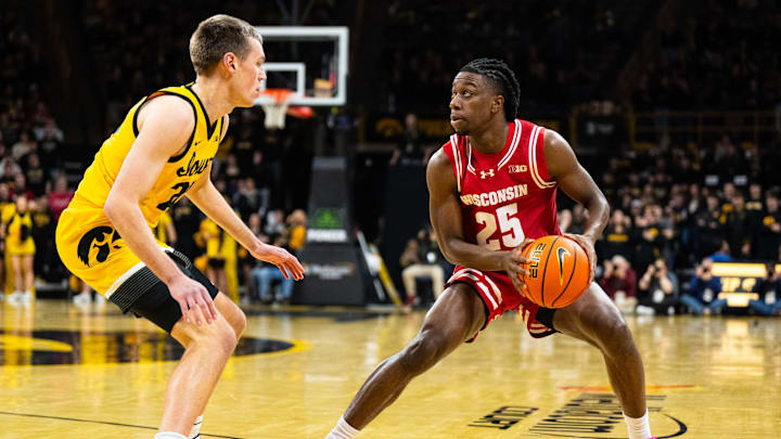 Feb 8, 2025; Iowa City, Iowa, USA; Wisconsin Badgers guard John Blackwell (25) looks to shoot against Iowa Hawkeyes forward Payton Sandfort (20) during the first half at Carver-Hawkeye Arena. Mandatory Credit: Dylan Widger-Imagn Images