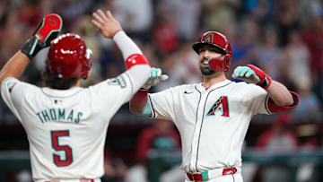 Sep 29, 2024; Phoenix, Arizona, USA; Arizona Diamondbacks outfielder Randal Grichuk (15) slaps hands with Arizona Diamondbacks outfielder Alek Thomas (5) after hitting a home run against the San Diego Padres during the eighth inning at Chase Field. Mandatory Credit: Joe Camporeale-Imagn Images