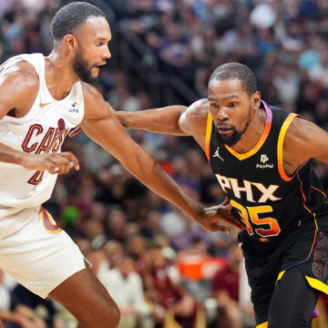 Apr 3, 2024; Phoenix, Arizona, USA; Phoenix Suns forward Kevin Durant (35) dribble against Cleveland Cavaliers forward Evan Mobley (4) during the first half at Footprint Center. Mandatory Credit: Joe Camporeale-USA TODAY Sports