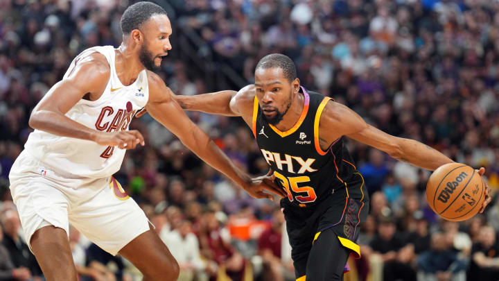 Apr 3, 2024; Phoenix, Arizona, USA; Phoenix Suns forward Kevin Durant (35) dribble against Cleveland Cavaliers forward Evan Mobley (4) during the first half at Footprint Center. Mandatory Credit: Joe Camporeale-USA TODAY Sports
