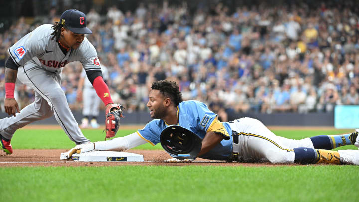 Aug 16, 2024; Milwaukee, Wisconsin, USA; Milwaukee Brewers outfielder Jackson Chourio (11) slides into third base ahead of the tag by Cleveland Guardians third base José Ramírez (11) for a triple in the first inning  at American Family Field. Mandatory Credit: Michael McLoone-USA TODAY Sports