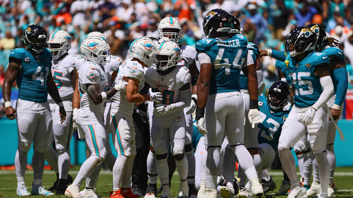 Miami Dolphins running back De'Von Achane (28) celebrates with teammates after scoring a touchdown against the Jacksonville Jaguars during the second quarter at Hard Rock Stadium. 