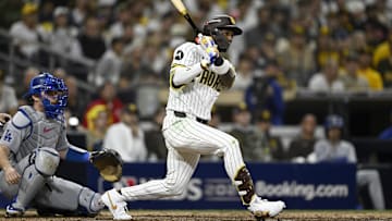 Oct 9, 2024; San Diego, California, USA; San Diego Padres outfielder Jurickson Profar (10) singles in the eighth inning against the Los Angeles Dodgers during game four of the NLDS for the 2024 MLB Playoffs at Petco Park.  Mandatory Credit: Denis Poroy-Imagn Images