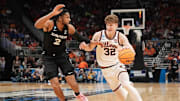Illinois guard Kasparas Jakucionis (32) drives to the basket against Xavier forward Jerome Hunter (2) in an NCAA Tournament game at Fiserv Forum in Milwaukee, Wisconsin on Friday, March 21, 2025.