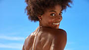 Tanaye White was photographed by Ben Watts in Barbados. Swimsuit by Bāben. Earrings by BaubleBar.