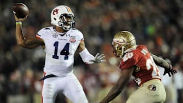 Auburn quarterback Nick Marshall (14) gets a pass away while defended by Florida State defenscive back Lamarcus Joyner (20) in second half action of the BCS National Championship Game on Monday January 6, 2014 in Pasadena, Ca.