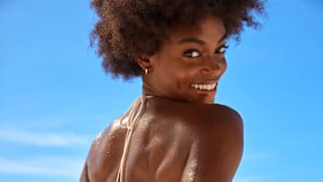 Tanaye White was photographed by Ben Watts in Barbados. Swimsuit by Bāben. Earrings by BaubleBar.