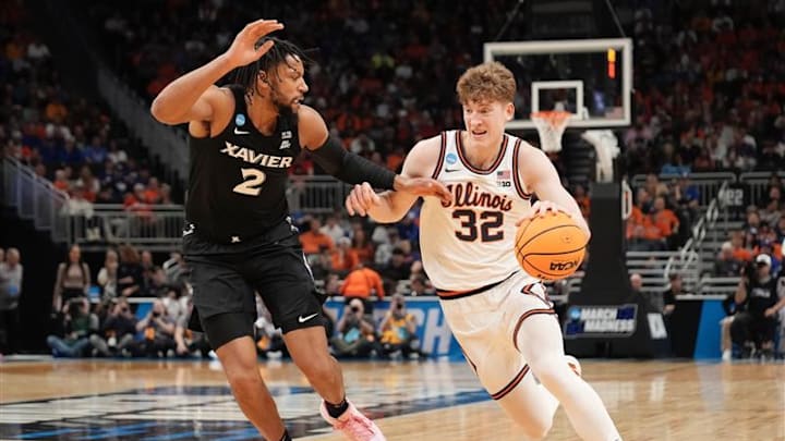 Illinois guard Kasparas Jakucionis (32) drives to the basket against Xavier forward Jerome Hunter (2) in an NCAA Tournament game at Fiserv Forum in Milwaukee, Wisconsin on Friday, March 21, 2025. Illinois guard Kasparas Jakucionis (32) drives to the basket against Xavier forward Jerome Hunter (2) in an NCAA Tournament game at Fiserv Forum in Milwaukee, Wisconsin on Friday, March 21, 2025.