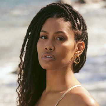 Leyna Bloom was photographed by Amanda Pratt in Dominica. Swimsuit by Norma Kamali. Earrings by Alexis Bittar.