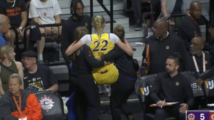 Los Angeles Sparks rookie Cameron Brink is carried off the court by trainers after an injury against the Connecticut Sky. 